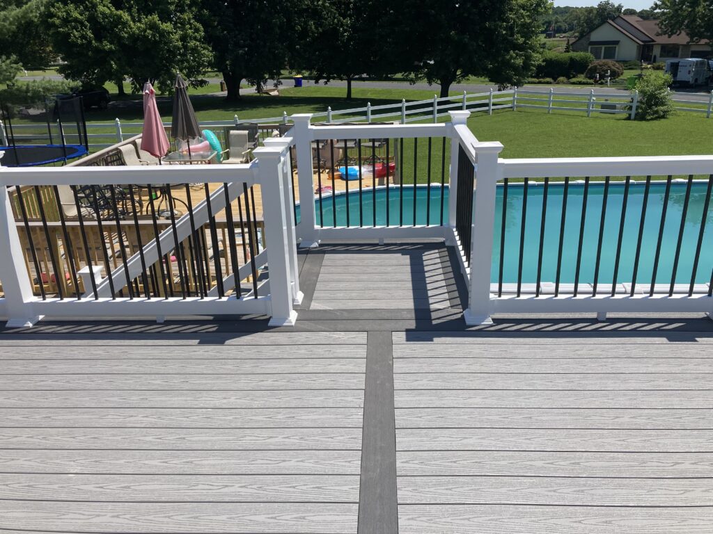 The large deck installation opens to steps down to a pool area.