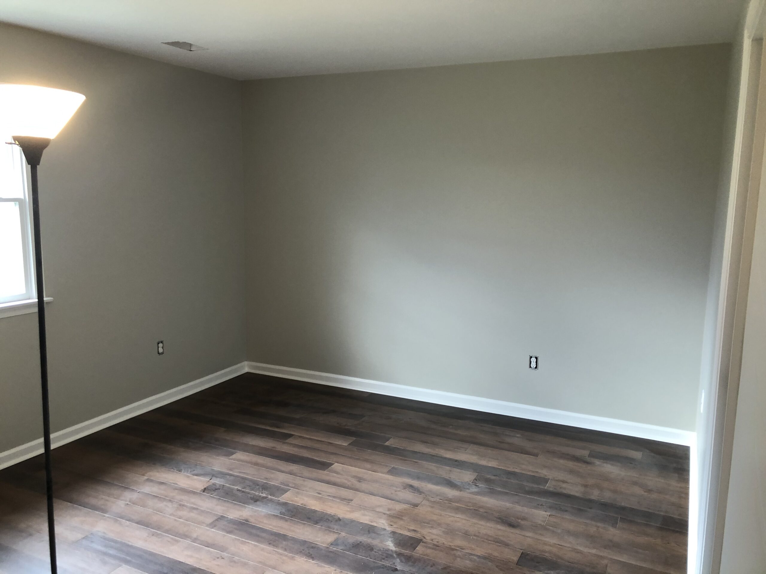 Newly renovated room with fresh clean walls and gorgeous dark hardwood floor