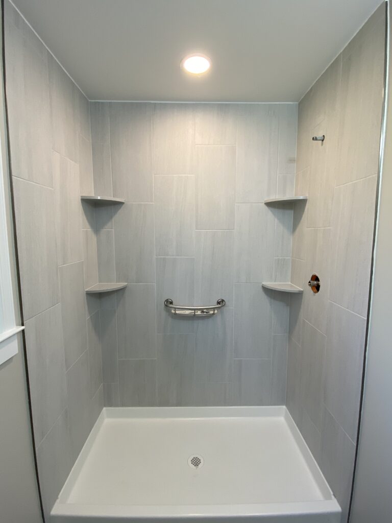 The shower stall interior with modern fixtures and clean lighting.
