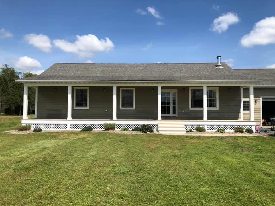 Exterior of a one level home after renovation with a beautiful new front porch