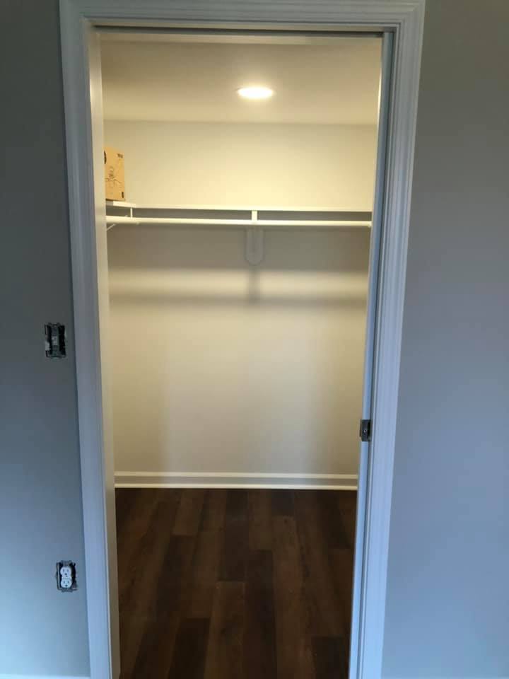Newly renovated closet with built-in lighting and hardwood floors